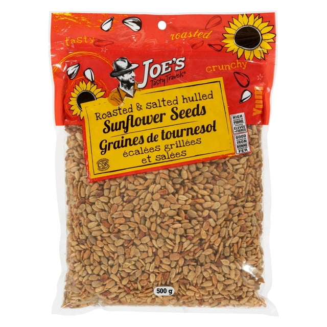 Roasted & salted hulled sunflower seeds in a 500g clear plastic bag with a red and yellow label from Joe's Tasty Travels, featuring sunflower graphics and bilingual English and French text highlighting a crunchy, tasty snack rich in fiber and iron, ideal for salads and granola.