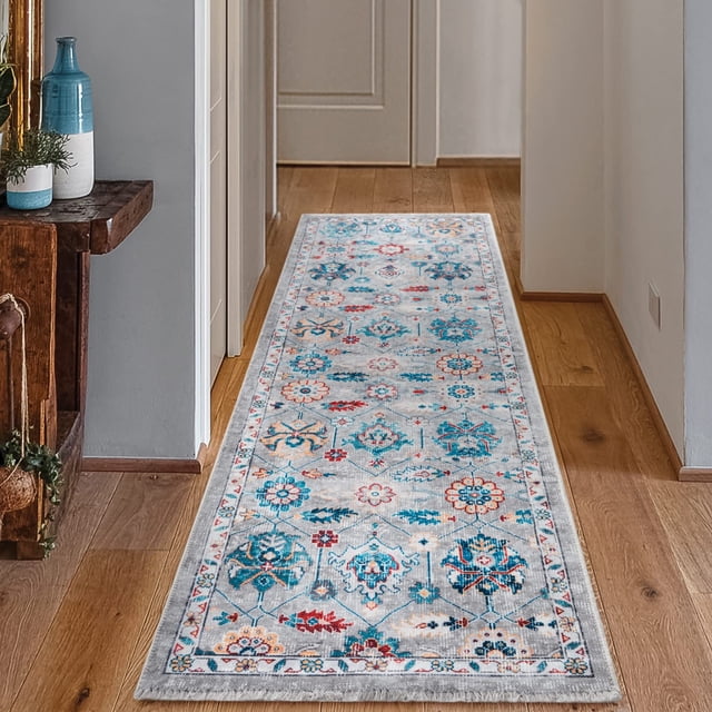 BY COCOON 2'x6' runner rug with a low pile thickness of 0.2 inches, shown in a hallway. The rug has a colourful floral and geometric design in blue, red, and orange on a light grey base. Made in Turkey, it is washable, non-slip, stain-resistant, and easy-care, perfect for high-traffic areas like entryways, kitchens, and hallways.