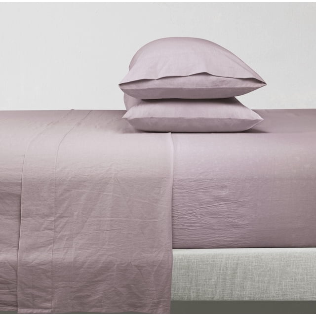 Cotton Solid Prewashed sheet Set in mauve with a fitted sheet designed for mattresses up to 14 inches thick, a flat sheet draped over the bed edge, and two matching pillowcases stacked, made from breathable 100% cotton fabric featuring natural soft wrinkles, ideal for refreshing bedroom bedding.