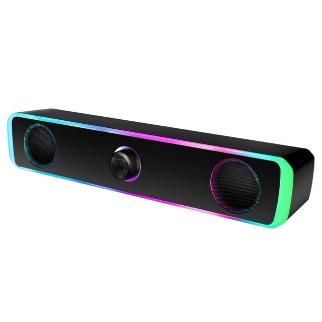 Computer speakers for desktop with a sleek black design featuring RGB lighting along the edges. The compact speaker bar includes two circular speaker units and a central volume control knob. USB-powered and compatible with PCs, laptops, and smartphones, it offers stereo audio for gaming, movies, and music.
