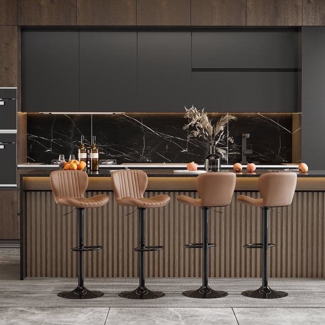 Walsunny Adjustable Bar Stools Set of 4 in brown PU leather upholstery, featuring swivel counter-height seats with a scalloped design and large black metal bases. These stools offer adjustable height and a non-slip base, making them ideal for modern kitchens or dining spaces. Displayed in a contemporary kitchen with a marble backsplash and wooden cabinetry.
