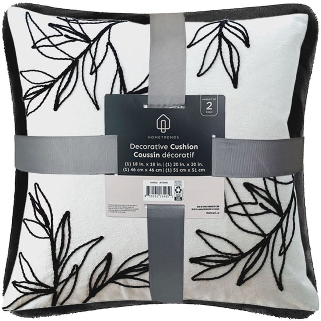Hometrends Embroidered 2 Pack Decorative Pillows with one 18 in. x 18 in. and one 20 in. x 20 in. plush velvet cushions in white featuring black embroidered leaf patterns, wrapped with gray ribbons, suitable for adding layered texture to home décor.
