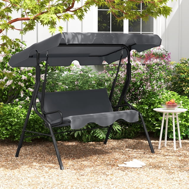 Costway Patio 3 Seats Canopy Swing Glider Hammock with a steel frame and cushioned seating in grey. Designed for outdoor use, it features a 45° adjustable polyester canopy for sun and rain protection, curved armrests, and a sturdy A-shaped metal frame with non-slip foot pads. Ideal for gardens, patios, or backyards, this porch swing offers comfortable seating for up to three people.