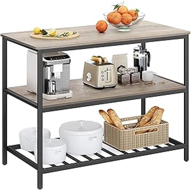 VASAGLE Kitchen Island with 3 Shelves, featuring a 47.2-inch greige and black worktop supported by a stable steel structure. The 3-tier design includes a spacious top surface for food preparation or appliances, a middle shelf for storage, and a lower grid shelf for bakeware or baskets. Adjustable feet ensure stability on uneven floors. Made of particleboard and steel, this industrial-style kitchen island is easy to assemble and versatile for use as a breakfast table, coffee bar, or serving station.