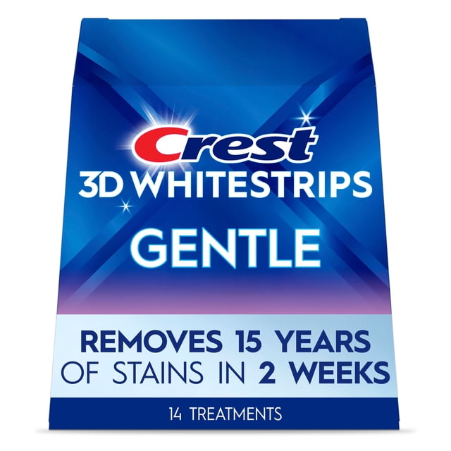 Crest 3DWhitestrips Gentle at-home teeth whitening kit in blue and purple packaging, removes 15 years of stains in 2 weeks with 14 enamel-safe treatments, designed for sensitive teeth with no-slip grip technology for comfortable whitening.