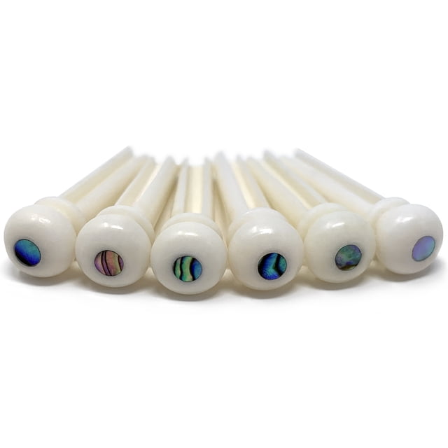 Crosby Slotted Pure Bone Bridge Pins with Abalone Dot Inlay for 6 & 12 String Acoustic Guitar. A close-up view of six white ox bone bridge pins with abalone dot inlays, crafted to improve tone, sustain, and volume. Ideal for guitar accessories, fitting most acoustic guitars like Martin, Taylor, and Yamaha models.