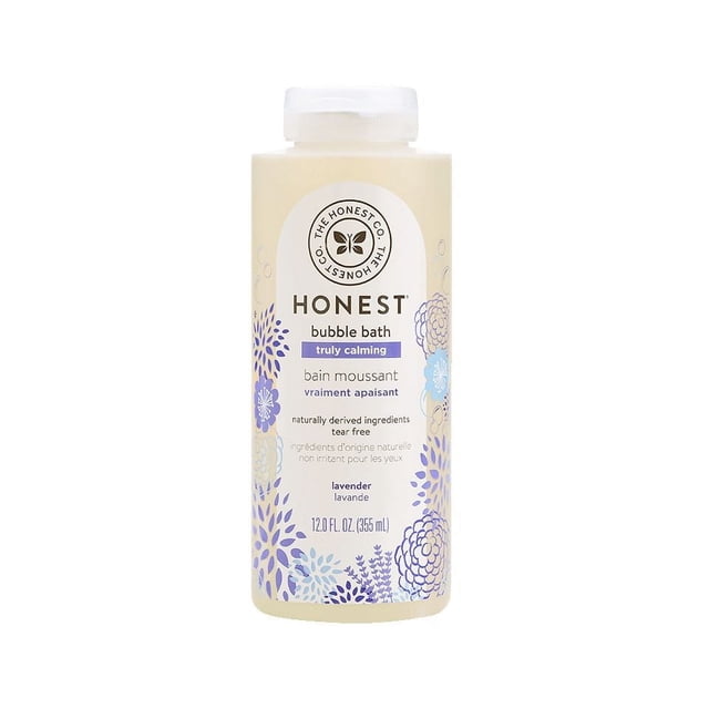 The Honest Company Bubble Bath Truly Calming Lavender in a 12 fl oz (355 ml) translucent bottle with white flip-top cap, featuring a beige label with blue and purple floral patterns, made with naturally derived, tear-free ingredients for sensitive skin.