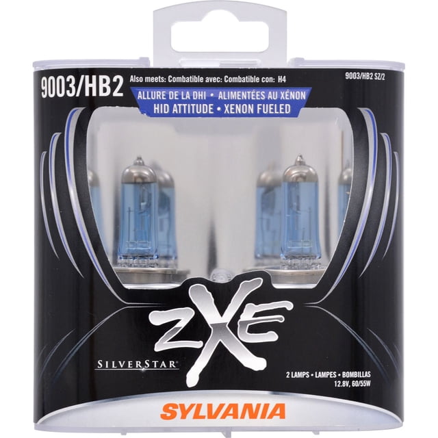 SYLVANIA 9003 zXe Halogen Headlight bulbs in black and silver packaging showing two blue-tinted halogen lamps with cobalt blue coating, designed for automotive replacement parts and exterior car lighting with xenon-fueled HID attitude technology.