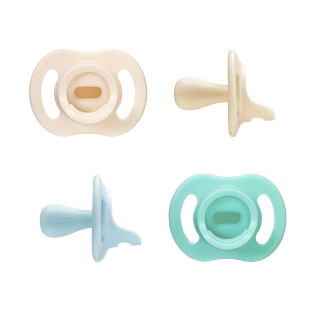 Tommee Tippee Ultra-light StayPut Pacifier, 0-6m, 4 Count, one-piece silicone pacifiers in beige and light blue, shown from front and side views. Features symmetrical nipple and ventilated shield for airflow, designed to stay put and soothe babies longer.