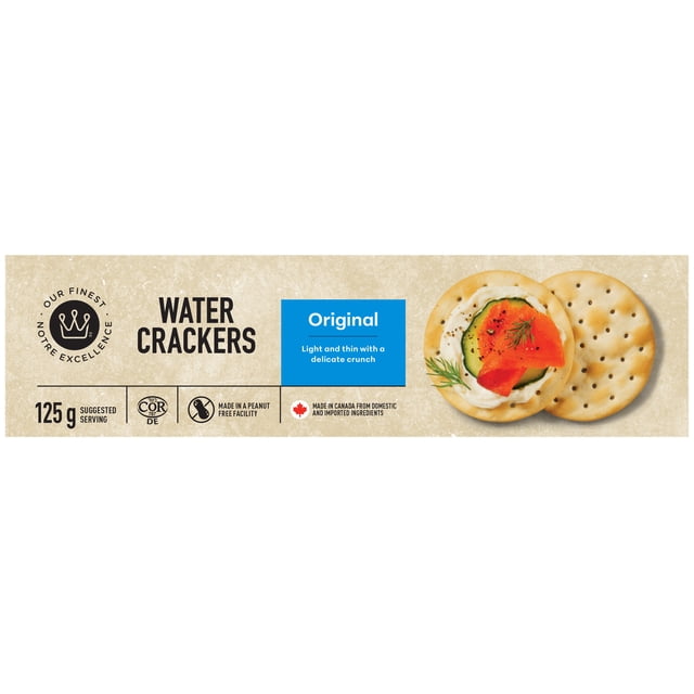 Our Finest Original Water Crackers package showing 125 g serving size, kosher and peanut-free facility labels, with round, light-textured crackers topped with cream cheese, cucumber, smoked salmon, and dill on a beige background, suitable for snacks and appetizers.
