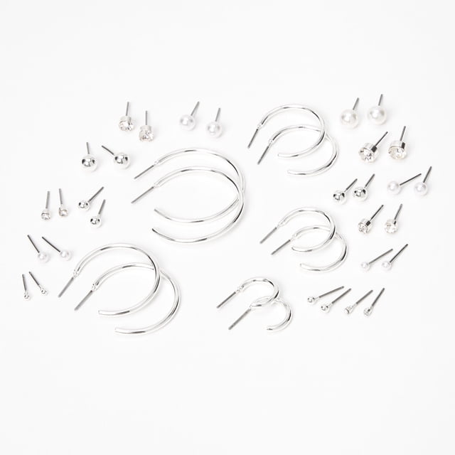 Claire's 20pk Silver Studs Crystals Hoop Earrings arranged neatly, showcasing a versatile collection of silver-tone jewelry. Includes sparkling crystal studs, pearl accents, and statement hoops, ideal for casual or formal outfits. A perfect addition to your statement earrings collection.