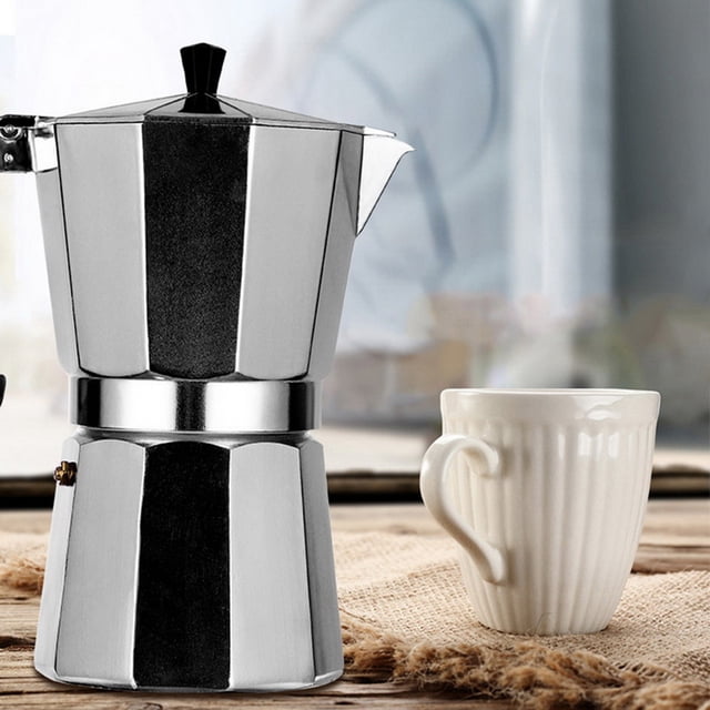 50/100/150/300/450/600ml Coffee Maker Espresso Percolator Stove Top Pot Kettle made from food-grade aluminum with a polished surface, shown in a kitchen setting alongside a white ceramic mug. Features a long handle and compact design suitable for electric, ceramic, and gas stoves. Often used for brewing rich espresso at home.