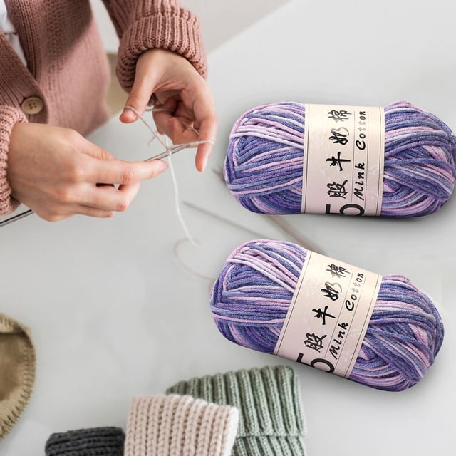 Clearance Tyidzon Wool Yarn for Crocheting, featuring lightweight milk cotton gradient yarn in purple and pink tones. Two 50g rolls are shown, each 1mm thick and 325m long, ideal for arts and crafts, DIY projects, crocheting, hand knitting, and crafting. A person is seen crocheting in the background with knitted items nearby.