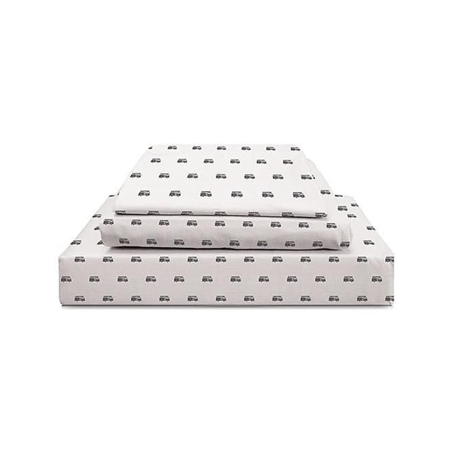Johnson Home 200 TC Bed Sheet Set - Printed Cotton Sheets in white with a repeating small black vintage car print, neatly folded with flat sheet, fitted sheet, and pillowcase stacked front-facing, made from breathable 200 thread count cotton for softness and year-round comfort.