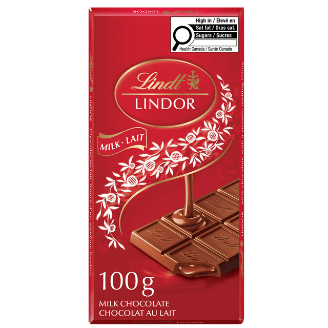 Lindt LINDOR Milk Chocolate Bar, 100 g, with a red package featuring the Lindt logo and white floral design. The front shows 12 milk chocolate squares, one melting to reveal a smooth creamy center. Includes bilingual text and a Health Canada label for high saturated fat and sugars.