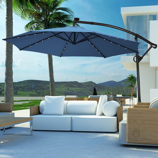 Costway 10FT Patio Offset Umbrella Solar Powered LED 360Degree Rotation Aluminum Blue. This outdoor umbrella features a 10-foot blue polyester canopy supported by 8 steel ribs and a powder-coated aluminum pole. It includes 24 solar-powered LED lights, with 3 lights on each rib, for nighttime illumination. The umbrella offers 360-degree rotation and tilt adjustment via a gliding handle for optimal shade positioning. Designed with a vented top for airflow, it is weather-resistant and suitable for gardens, backyards, poolside, or beach settings. A cross base is included for stability.