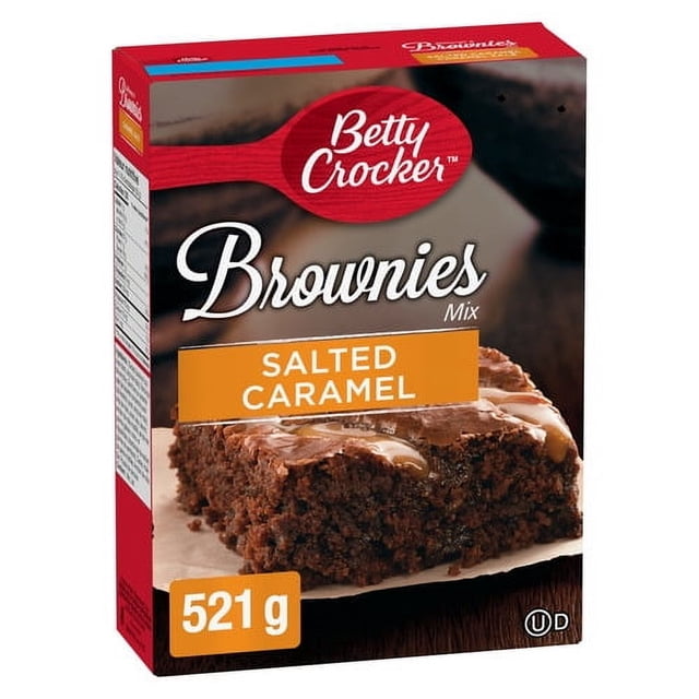 Betty Crocker Salted Caramel Brownies Mix box showing a close-up of a moist brownie square topped with salted caramel drizzle, weighing 521 grams, ideal for easy baking and homemade dessert preparation.