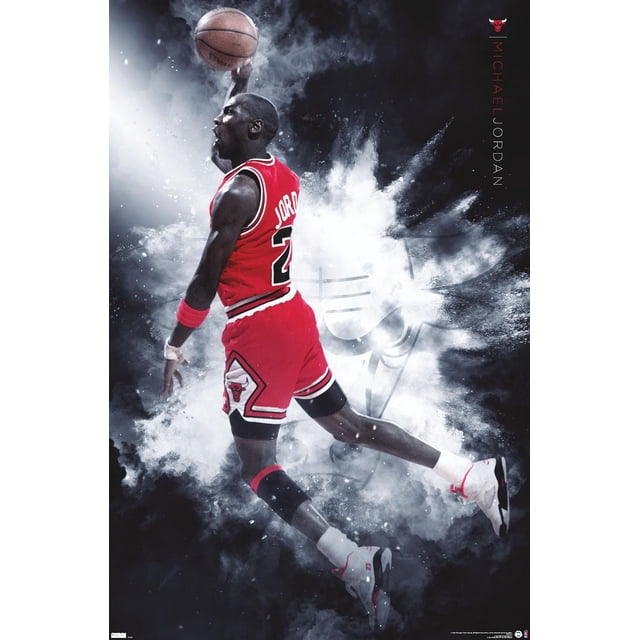 Michael Jordan - Burst Wall Poster, 22.375" x 34" showing Michael Jordan in a red Chicago Bulls basketball uniform with number 23, captured mid-air holding a basketball for a dunk against a smoky black and white background featuring a faint Chicago Bulls logo and vertical text reading Michael Jordan.