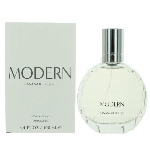 Banana Republic Modern par Banana Republic Vaporisateur Edt 3,4 Oz, un Parfum pour Femmes Lancé en 2014, Présentant un Mélange Frais et Chaud aux sous-Tons Sucrés et Épicés. l'Image Montre une Bouteille Ronde en Verre Transparente avec « Modern » et « Banana Republic » Imprimés sur le devant, aux Côté de l'Emballage en Boîte Blanche Assorti.