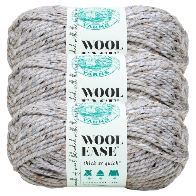 Lion Brand Wool-Ease Thick & Quick Yarn #6 Super Chunky Wool Acrylic Yarn 3-Pack in light oatmeal with brown and grey flecks, showing three skeins stacked horizontally with labels displaying the brand logo and product name, ideal for warm sweaters, hats, and accessories.
