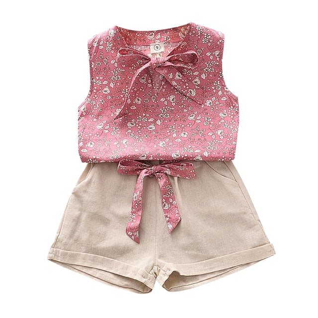 Little Girls Outfits Set featuring a sleeveless pink floral pattern top with a bow tie detail, paired with beige solid color pocketed shorts and a matching floral belt. Designed for summer wear, this outfit is available in size 6T and is suitable for various occasions such as birthdays, photo shoots, and outdoor activities.