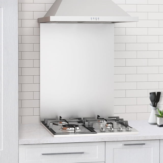 Ancona 24 in Natural Gas Cooktop with 4 Brass Burners installed on a white countertop in a modern kitchen setting. The cooktop features a stainless steel top with four brass burners, including a triple-ring super rapid burner, two semi-rapid burners, and an auxiliary burner. Cast iron grates provide durability, and brushed stainless steel control knobs add elegance. The background includes a white tiled backsplash and a stainless steel range hood.