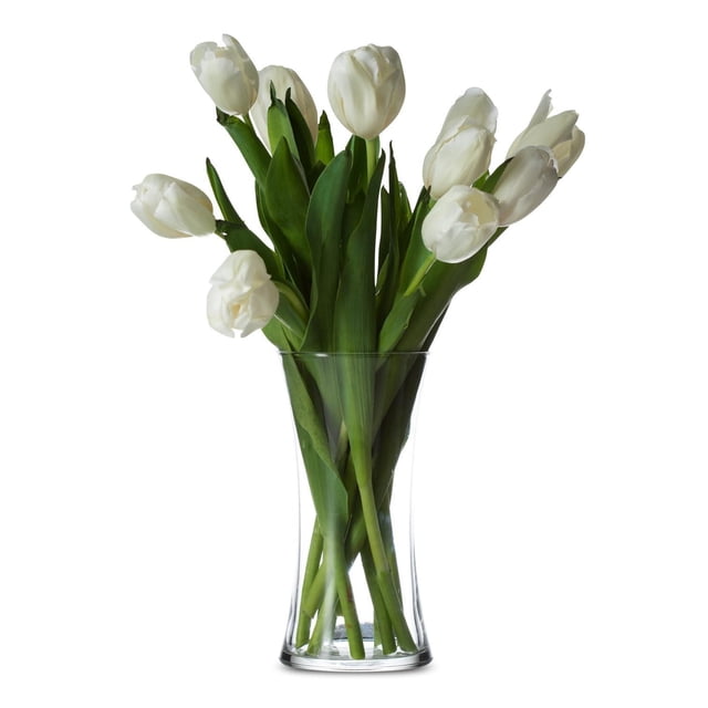 Sidney Vase with a slim, curvaceous clear glass design holding white tulips with green leaves and stems, ideal for home decorative accents and special occasions, also suitable as an elegant centerpiece.