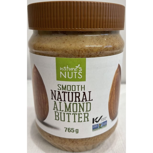 Nature's Nut Smooth Natural Almond Butter in a clear plastic jar with a brown ribbed lid, containing 765 g of light brown smooth almond butter with visible almond specks, labeled with non-GMO and kosher certification marks, ideal for pantry storage and often used as a protein-rich spread.