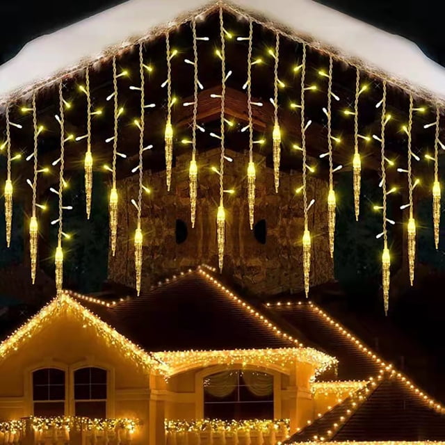 Dvkptbk Decorative Lights LED Ice Bar Lights, Icicle Lights Curtain Lights with eight function controller displayed outdoors. The lights feature warm white LED icicles hanging from a roofline, creating a festive ambiance. The 11.5-foot string includes 96 LEDs with flexible and durable wiring, suitable for indoor and outdoor use. Ideal for Christmas, weddings, and other celebrations.