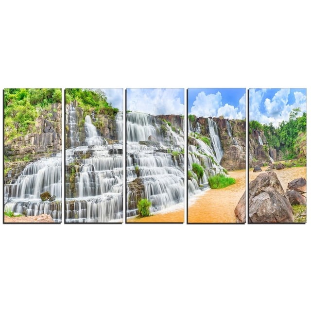 Design Art Pongour Waterfall Canvas Print featuring a five-panel gallery wrapped wall art of a cascading waterfall over rocky cliffs with lush greenery and a flowing river under a partly cloudy sky, printed on premium cotton canvas and ready to hang, ideal for enhancing home or office décor.