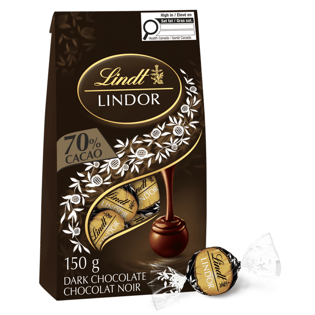 Lindt LINDOR 70% Cacao Dark Chocolate Truffles 150 g bag featuring individually wrapped truffles with a delicate dark chocolate shell and smooth melting centre, shown with a pouring chocolate swirl and white floral design on dark brown packaging, suitable for gifting or personal enjoyment.
