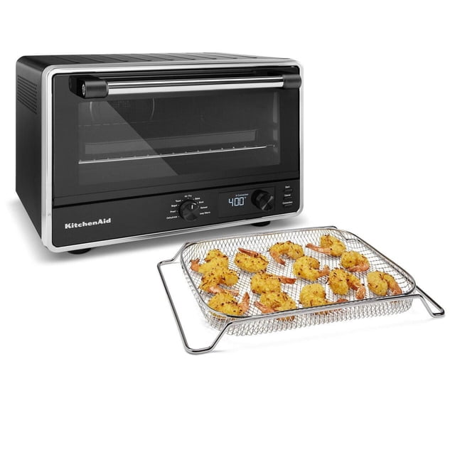 KitchenAid® Digital Countertop Oven with Air Fry in black and stainless steel with digital display set to 400°F, featuring removable no-flip air fry basket filled with breaded shrimp beside it, suitable for air frying and baking in a compact countertop design.