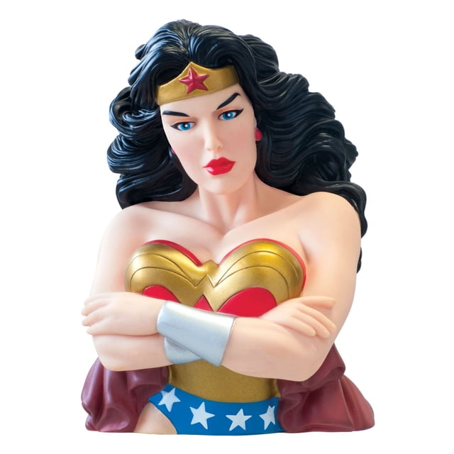 Monogram International DC Comics Wonder Woman Bank bust showing a front view of Wonder Woman's upper body with crossed arms, gold and red chest armor, silver wrist cuffs, blue star-spangled shorts, and sculpted black hair made of roto-cast plastic, ideal as a piggy bank and desk decoration.