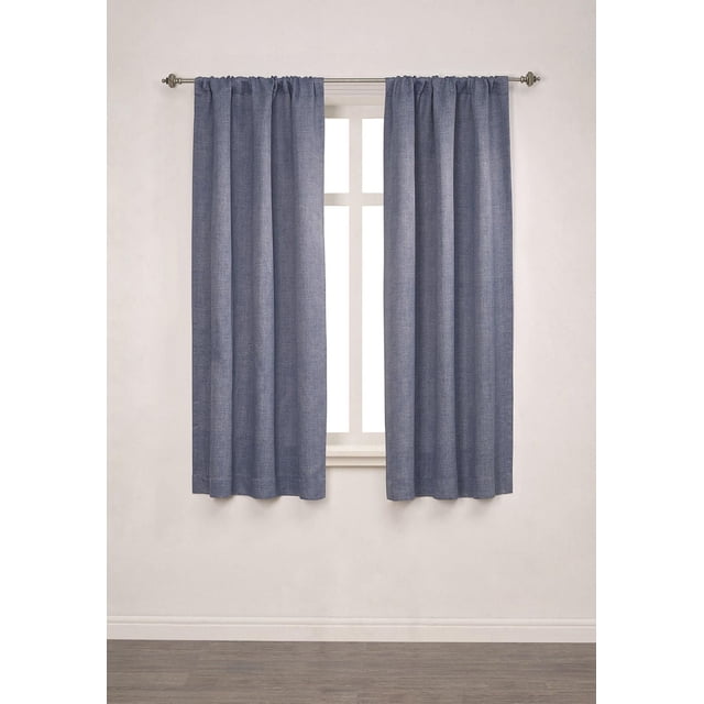 Mainstays Chambray Blackout 63" Window Curtains Panel Pair in Blue Moonlight, two textured polyester blackout panels with rod pocket hanging on a metal rod, each 40 inches wide and 63 inches long, shown covering a window in a neutral room with wood flooring, designed for full light blockage and bedroom privacy, also suitable for media rooms needing light control.
