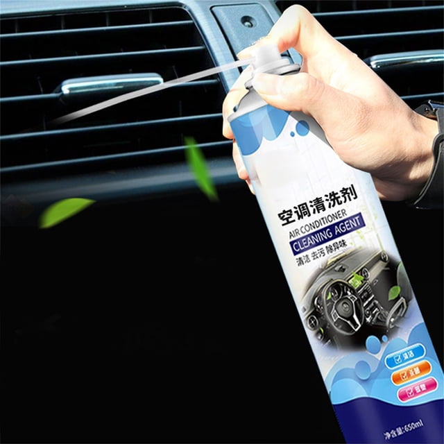 Ymiko Air Conditioner Cleaning Agent in a spray can, designed for automotive air conditioners and car interiors. The image shows a hand spraying foam cleaner into a car air vent, with green leaves symbolizing freshness. The product is eco-friendly, non-toxic, and effective for removing dirt, odors, and harmful microorganisms, leaving a faint fragrance. The can features a 650ml capacity and a detailed label with product information.