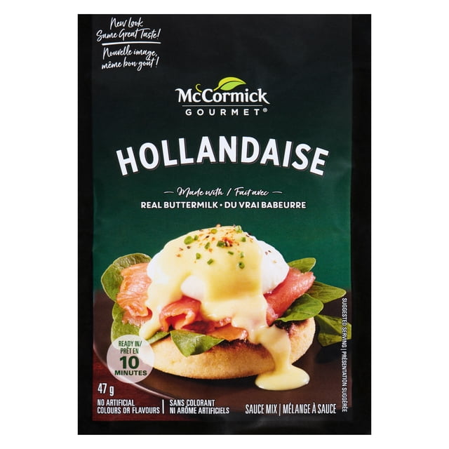 McCormick Gourmet Hollandaise Sauce Mix package with dark green background and white text, highlighting real buttermilk and no artificial colours or flavours. The front shows Hollandaise sauce poured over smoked salmon, spinach, and a poached egg on an English muffin, ready in 10 minutes, suitable as a convenient cooking sauce for pantry use.
