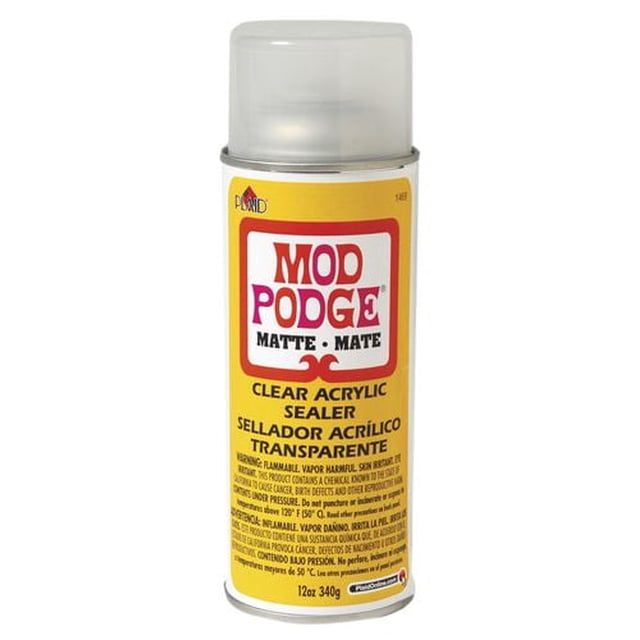 Mod Podge Acrylic Sealer Matte 12 oz aerosol spray can with clear plastic cap and yellow label, providing a matte clear acrylic finish that protects paint, wood, and decoupage craft projects, often used for durable sealing on multiple surfaces.