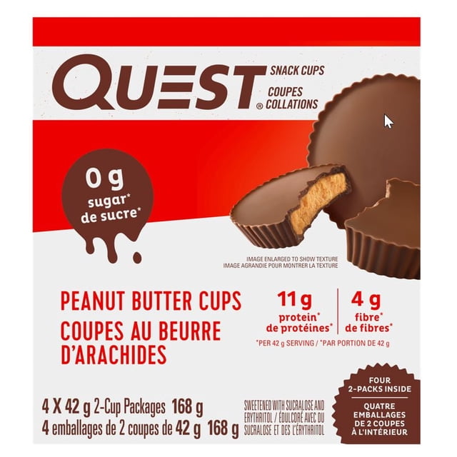 Quest Peanut Butter Cups 4 Pack with four chocolate peanut butter cups, one cut open to reveal creamy peanut butter filling, offering 11g protein, 4g fibre, and 0g sugar per 42g serving, suitable for a low-sugar snack.