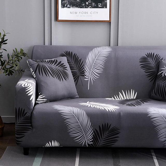 Peahefy Waterproof Elastic Dustproof Slipcover Sofa Cover Cushion Protector in a grey base with white and black leaf patterns. Made of 95% polyester and 5% spandex, it is shown fitted on a sofa with matching cushions in a modern living room setting. Designed to protect furniture from spills, stains, and wear, it is suitable for armchairs, love-seats, and couches of various sizes.