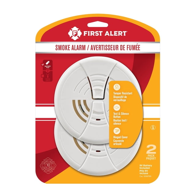 First Alert 1039755 smoke alarm 2-pack with tamper-resistant locking pin, test and silence button, hinged cover, and dual ionization sensing chamber, includes 9V battery, suitable for residential and institutional applications with bilingual English and French packaging.