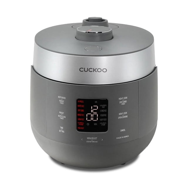 CUCKOO CRP-ST1009FG 10-Cup (Uncooked) / 20-Cup (Cooked) Twin Pressure Rice Cooker & Warmer in gray, featuring a nonstick inner pot, 16 menu modes, and a digital display. The front panel shows cooking options like GABA rice, white rice, and steam, with dual pressure settings for high-pressure or non-pressure cooking. Includes a 3-language voice guide and an auto-clean function for convenience.
