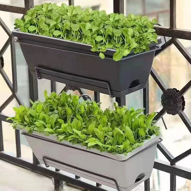 Becaristey Garden Planter Box Good Hanging Flowerpot in dark grey, designed for balcony decorations and outdoor gardening. The image shows two rectangular planter boxes, one in dark grey and the other in light grey, mounted on a balcony railing. Both boxes are filled with lush green plants. The planter features a detachable tray, drainage holes for easy watering, and a space-saving design suitable for small balconies or patios.