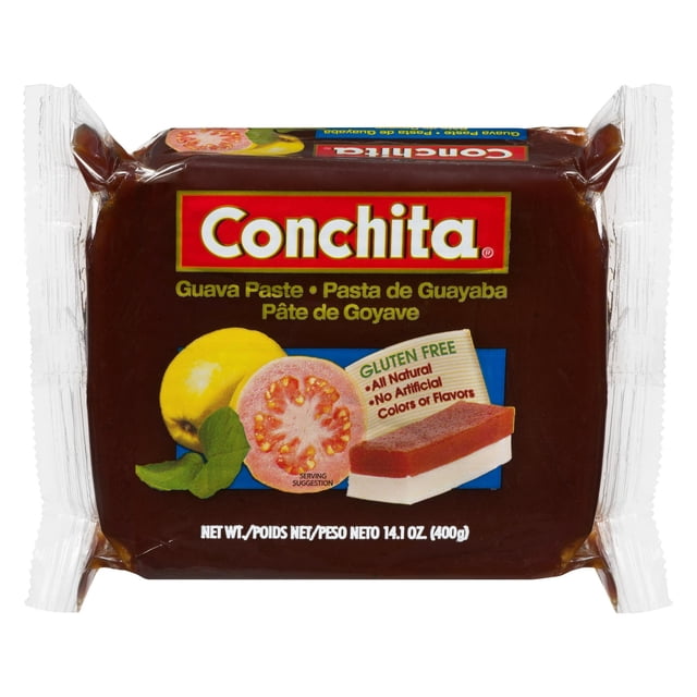 CONCHITA Pâte de Goyave en Bloc Rectangulaire Enveloppée dans un Plastique Transparent de Couleur Brun Rouge Foncé. l'Étiquette Montrer la Marque CONCHITA, des images de Goyave Entière et Tranchée, et une suggestion de Portion avec du Fromage Blanc. Elle Est Sans gluten, Entièrement Naturelle, et Sans Colorants Ni Arômes Artificiels, Pesant 400 g (14,1 oz). Cette Pâte de Goyave Convient pour Accompagner du Fromage à la Crème et des Craquelins Ou pour Ajouter une Touche Fruitée aux desserts et aux Collations.