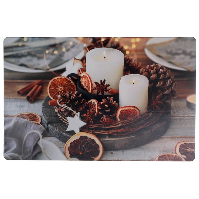 Plastic Placemat (Spiced Candles) - Set of 12 featuring a rustic design with two white pillar candles surrounded by pinecones, dried orange slices, star anise, and cinnamon sticks on a wooden table, perfect for protecting dining tables while adding countryside charm.