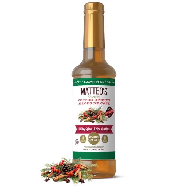 Matteo's Sugar Free Coffee Syrup, Holiday Spice flavor, in a 750mL bottle. The label emphasizes its sugar-free, calorie-free, and keto-friendly features. The bottle is adorned with festive imagery, including cinnamon sticks, star anise, and pinecones, reflecting its seasonal theme.