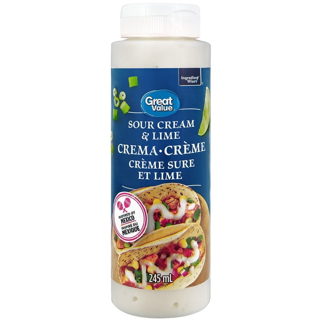Great Value Sour Cream and Lime Crema in a 245 ml white plastic squeeze bottle with a blue label featuring lime wedges, chopped green onions, and tacos topped with the smooth sour cream and lime sauce, inspired by Mexican cuisine and ideal as a topping or dip.
