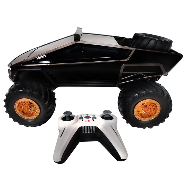 Hyper Toy Company 1:12 Scale Remote Control Monster Robo Truck with black angular body and heavy-duty off-road tires featuring orange rims, shown with a white and black 2.4GHz remote controller with dual joysticks and control buttons, suitable for rugged terrain play.