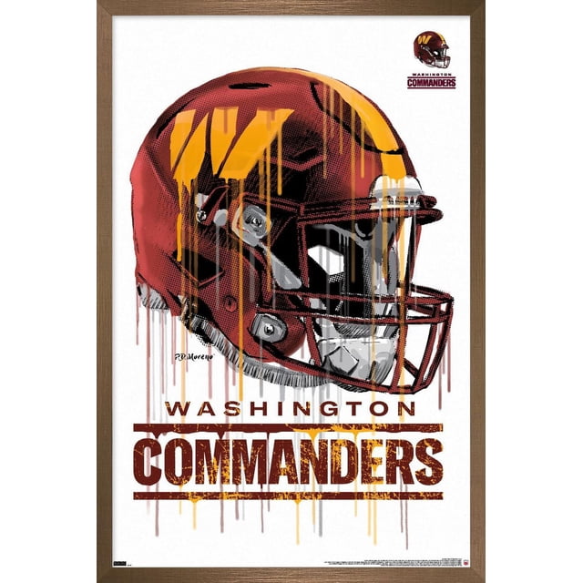 NFL Washington Commanders - Drip Helmet 22 Wall Poster, 14.725" x 22.375" framed featuring a front-facing stylized burgundy and gold football helmet with paint drip effects, the Washington Commanders logo in the top right, and bold distressed text reading 'Washington Commanders' below on a white background with a brown wooden frame, suitable for sports-themed home or office décor.