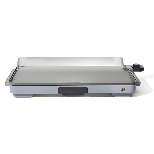 Beautiful XL Electric Griddle, 12" x 22" by Drew Barrymore, with a large PFOA/PFOS-free non-stick cooking surface, detachable stainless steel backsplash, slim design for easy cabinet storage, removable heat control dial from 200°F to 400°F, cool-touch handles, and a drip tray for collecting fats and oils.