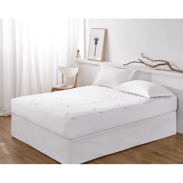 Marina Decoration Premium Luxury Ultra Soft Waterproof All Season Rayon from Bamboo Fitted Mattress Protector with deep pockets fitting mattresses up to 18 inches, shown on a bed with white pillows in a bright room with sheer curtains, wooden floor, a wooden chair with a cup and book, and a framed botanical print on a white ledge with decorative branches, ideal for protecting mattresses from spills and allergens.